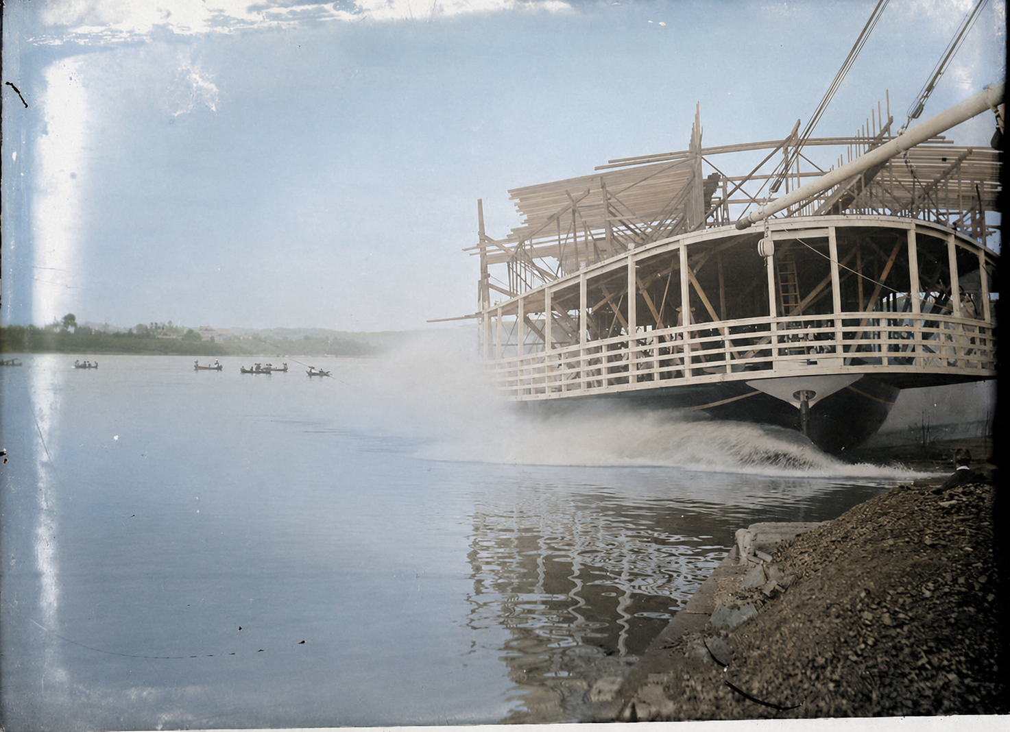 Colorized sidewheel steamboat launching scene